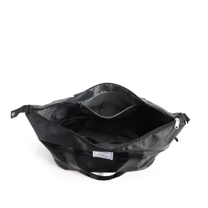 Detailed interior of black travel bag showing zipper pocket and digital compartments