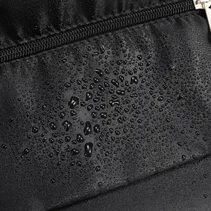 Macro shot of waterproof black fabric with water droplets and high-quality zipper detail
