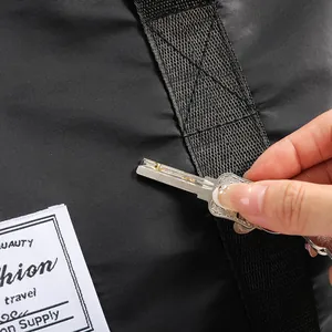 Macro detail of scratch-resistant black nylon fabric on travel bag with white woven label