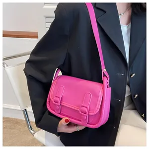 Fashionable magenta crossbody bag with flap cover worn over a black blazer jacket
