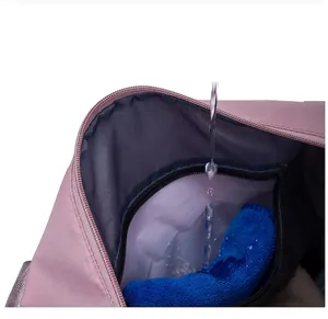 Detail of waterproof inner compartment for wet items in pink travel fitness bag