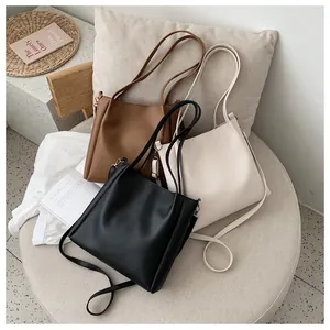 Close-up of minimalist large tote bags in black, brown and beige colors with PU leather texture