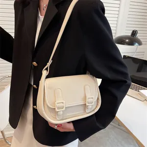 Chic off-white leather shoulder bag for women with dual buckle front and minimalist design