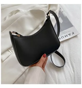 Close-up of black crescent shoulder bag with smooth PU leather and gold zipper detail