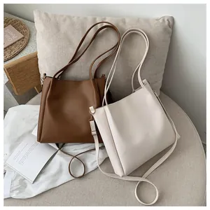 Detail of large brown and cream tote bags with dual straps in a lifestyle setting