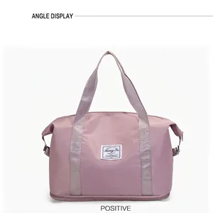 Front view of pink waterproof travel bag with bottom shoe compartment and soft handles