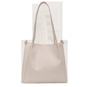 Minimalist beige leather tote bag with long shoulder straps for women, clean design