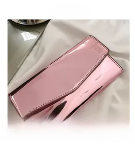 Detailed view of pink mirror patent leather envelope wallet with fine hand-stitched edges