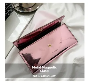 Pink metallic mirror wallet featuring a secure magnetic snap closure and fine stitching