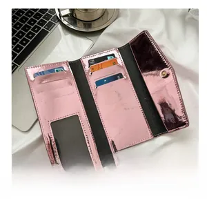 Pink metallic tri-fold wallet detail showing multiple card slots and clear ID window