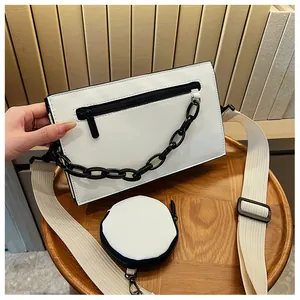 Detail of white PU leather crossbody bag set with black chunky chain and round coin purse