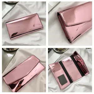 Detail of pink metallic envelope wallet showing card slots and spacious interior layout