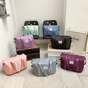 Multi-color waterproof nylon travel bags set with large capacity and luggage sleeve