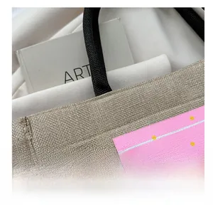 Macro shot of jute tote bag showing natural fiber texture and pink summer palm tree print