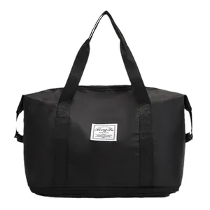 Large black travel duffel bag with bottom wet dry compartment and trolley sleeve