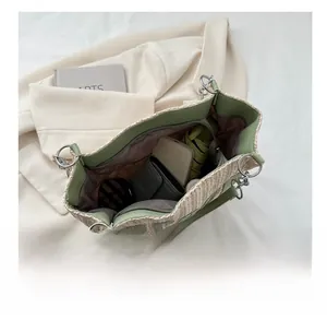 Top view of large straw tote bag showing spacious interior with various daily essentials