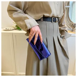 Model holding a glossy purple metallic long wallet with minimalist envelope flap design