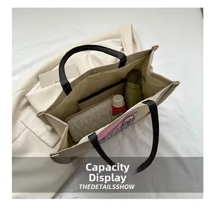 Internal view showing large capacity and side pocket of the canvas tote bag