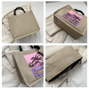 Detailed views of beige canvas tote bag with black handles and paradise summer palm print