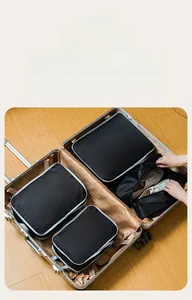 Detail of 4-piece compression travel organizer set with mesh panels in a silver suitcase