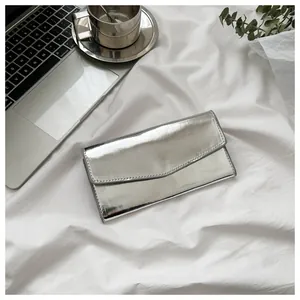 Detailed top view of a silver envelope wallet with metallic finish and neat stitching