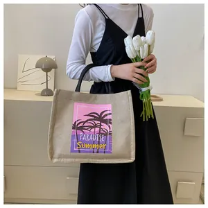 Detail of jute tote bag with PARADISE Summer sunset print and palm tree graphics