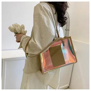 Detail of holographic PVC tote bag with khaki leather straps and inner pocket