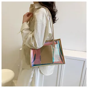 Detail of laser PVC tote bag with beige leather straps worn on shoulder by model