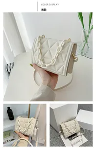 Detail of quilted crossbody bag in beige with decorative thick acrylic chain and gold buckle