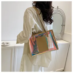 Detail of holographic PVC laser tote bag with khaki leather handles and inner pocket