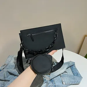 Minimalist black square crossbody bag with detachable coin purse and chunky chain detail