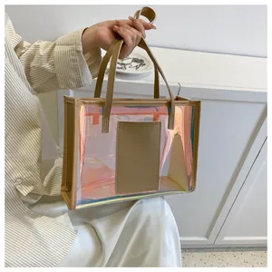 Macro detail of holographic PVC tote bag showing beige leather trim and iridescent surface