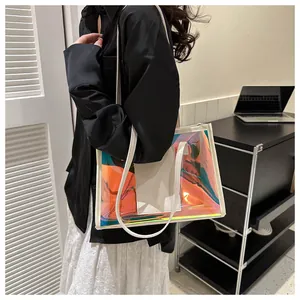 Detail view of large holographic PVC laser tote bag with white faux leather trim and strap