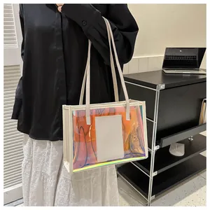 Iridescent PVC tote bag with cream leather trim shown worn on the shoulder in a modern room