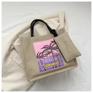 Macro detail of beige linen tote bag with paradise palm tree print and small pouch