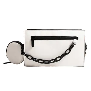 White minimalist crossbody envelope bag with black chain detail and small coin pouch