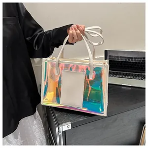 Detail of holographic PVC tote bag with white leather handles and iridescent finish