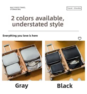 Detail of multi-size travel storage bags in grey and black shown inside a suitcase