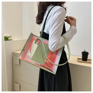 Detailed view of iridescent PVC tote bag with stylish sage green leather handles and pocket