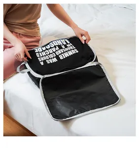 Detail view of a black waterproof travel packing cube holding a folded t-shirt