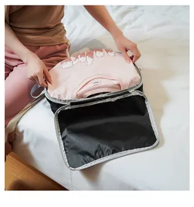 Detail of travel compression organizer bag with zipper and pink T-shirt storage inside