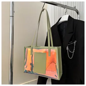 Holographic PVC tote bag detail featuring light green leather trim and dual handles
