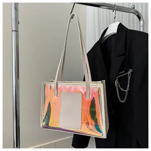 Detail of laser iridescent PVC tote bag with white leather trim on metal display