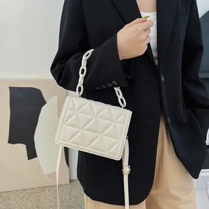 Chic beige quilted square shoulder bag with chunky acrylic chain and leather strap