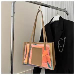 Close-up of the holographic laser PVC material and reinforced synthetic leather handles on the tote