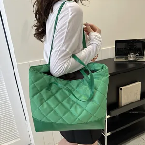 Modern green quilted tote bag with diamond stitching shown as a stylish shoulder bag