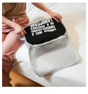 Detail of light gray travel organizer bag showing honeycomb nylon fabric and zipper storage