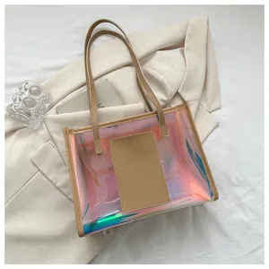 Detail of holographic PVC tote bag with stylish tan leather handles and inner pocket pouch