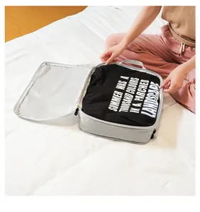 Detail of grey travel packing cube with mesh pocket showing clothes storage and zipper