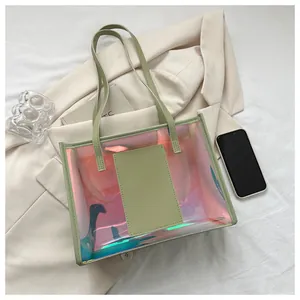 Detailed top view of large capacity iridescent laser tote bag with green handles